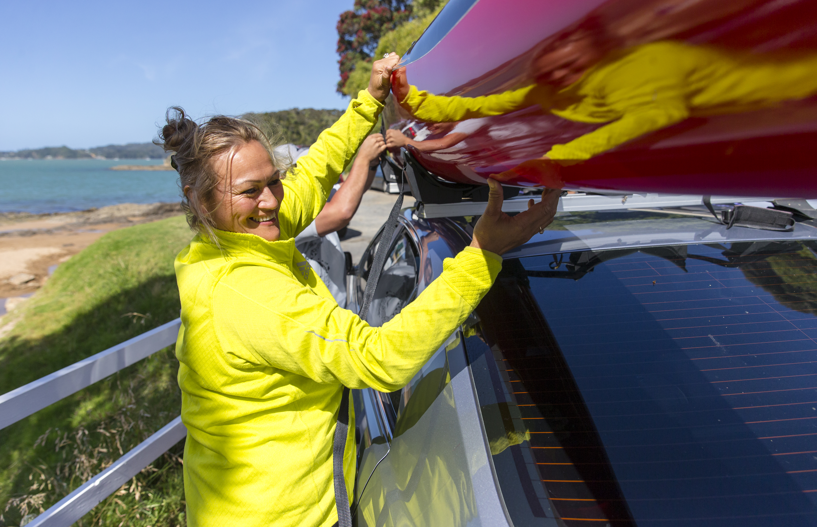 Iona adjusting a canoe on top of car