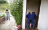 Wilson at the doorway while his daughter walks outside holding dogs
