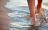 feet walking on a beach