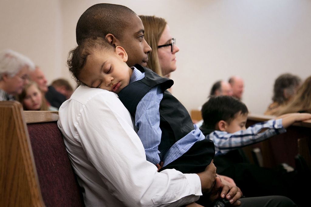 Tony and Marnie sit on a church pew learning about the gospel of Jesus Christ