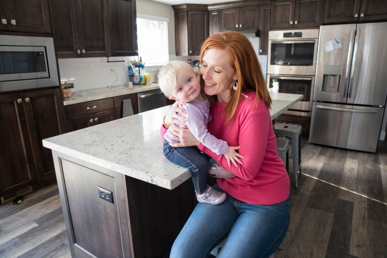 A mother plays and smilies with her son