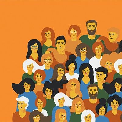 A group of people stand together smiling enjoying each others company