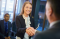 young woman shakes hands at interview
