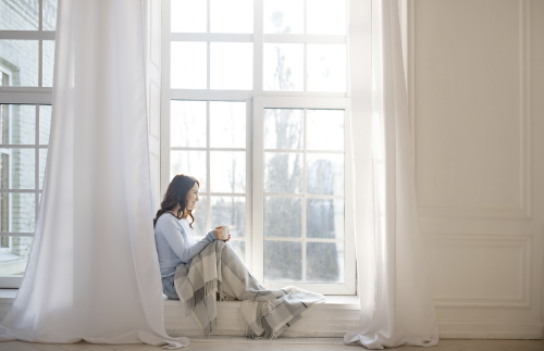 Woman sitting at a bay window