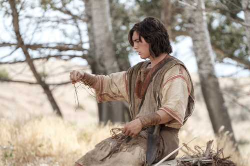 Nephi making a bow and arrow in the wilderness