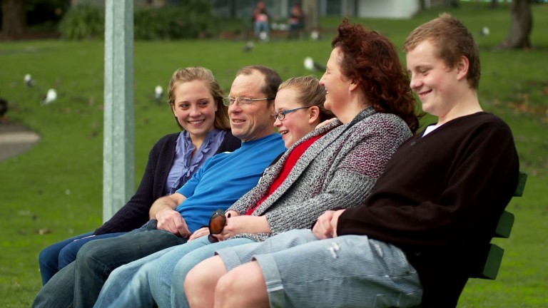 A family sit together on a bench enjoying the blessings of the gospel of Jesus Christ
