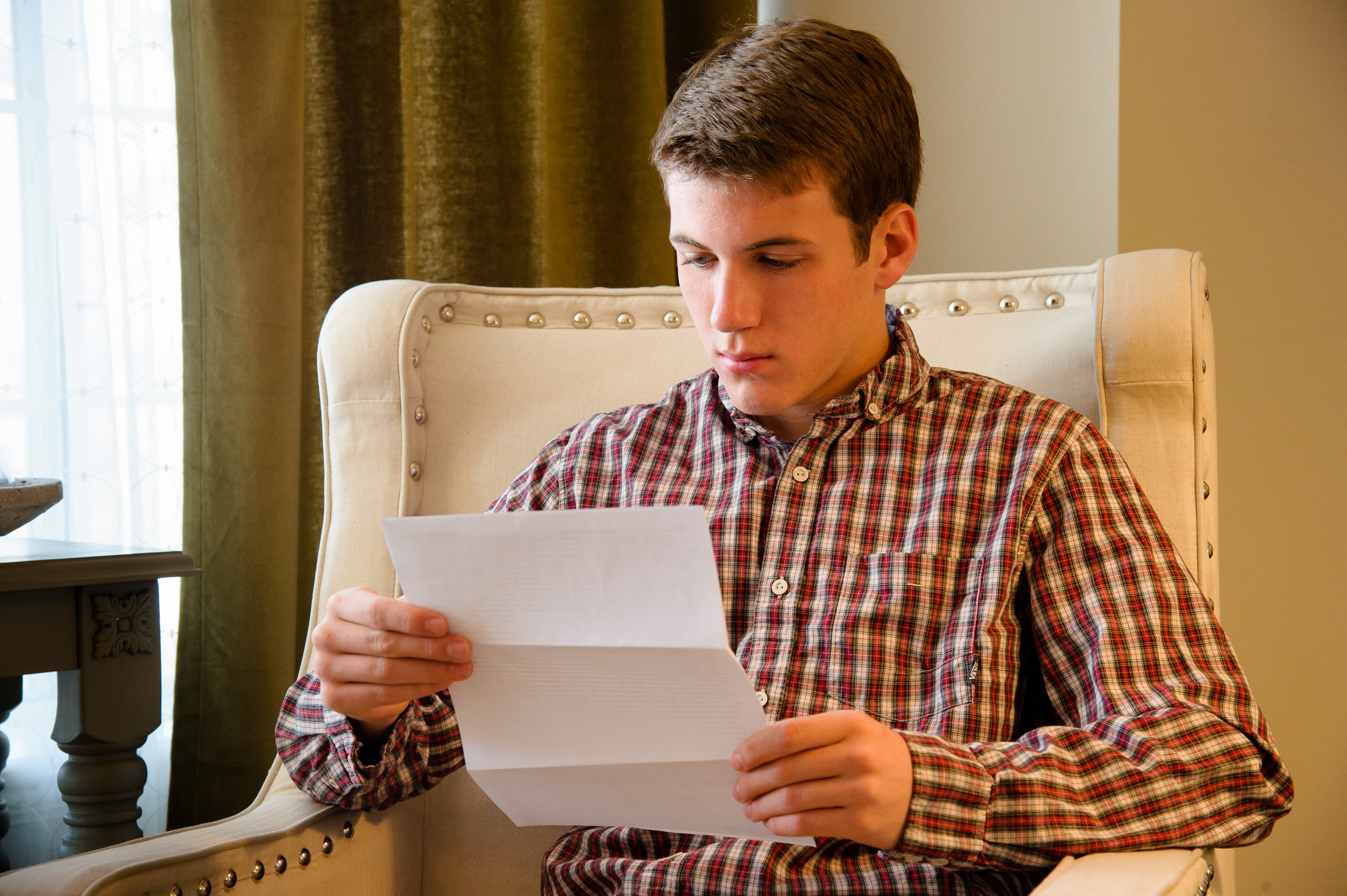 young man reading paper