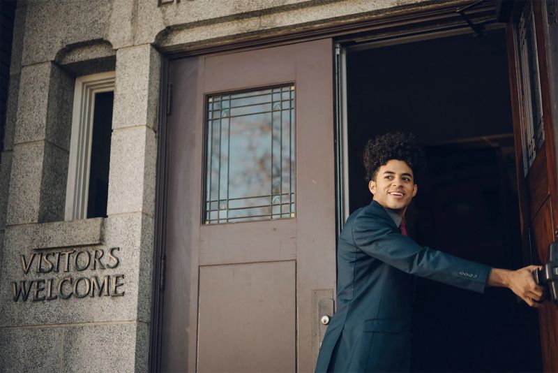 A man opens the door to a church building