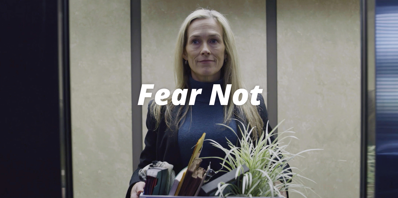 A woman walks into an office elevator carrying her things in a box after being let go finds strength in Psalm 23:1, 4