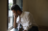 young adult man at window