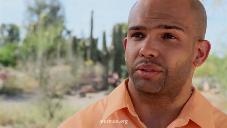 Man in orange shirt talking