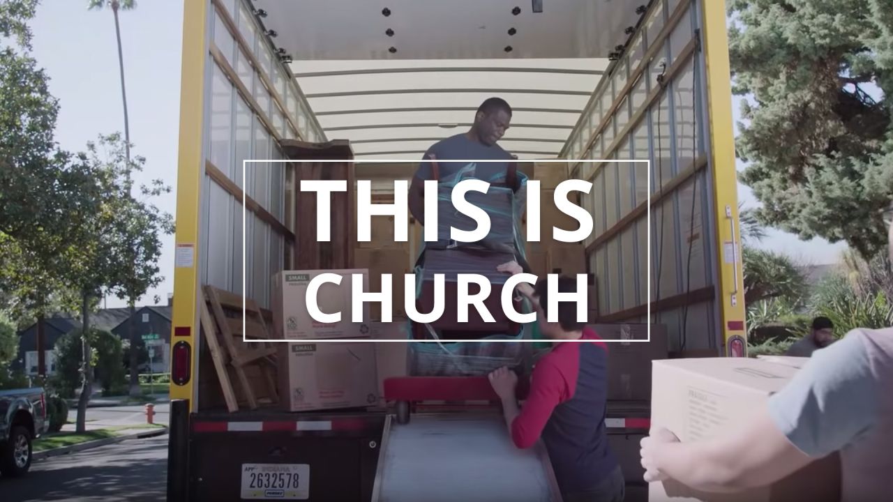 A man helps move furniture from a moving van
