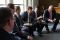 Men sit together in discussion