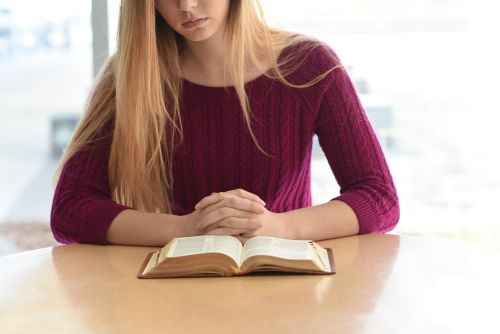 young woman reading her scriptures