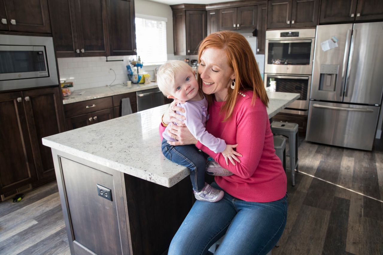 A mother plays and smilies with her son