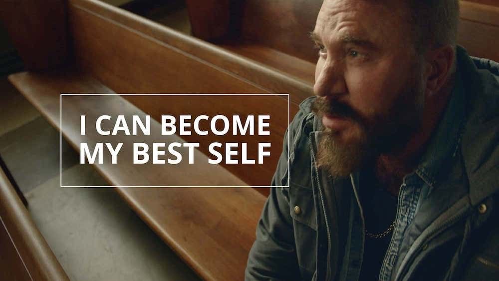 A man sits on a chapel bench contemplating the gospel