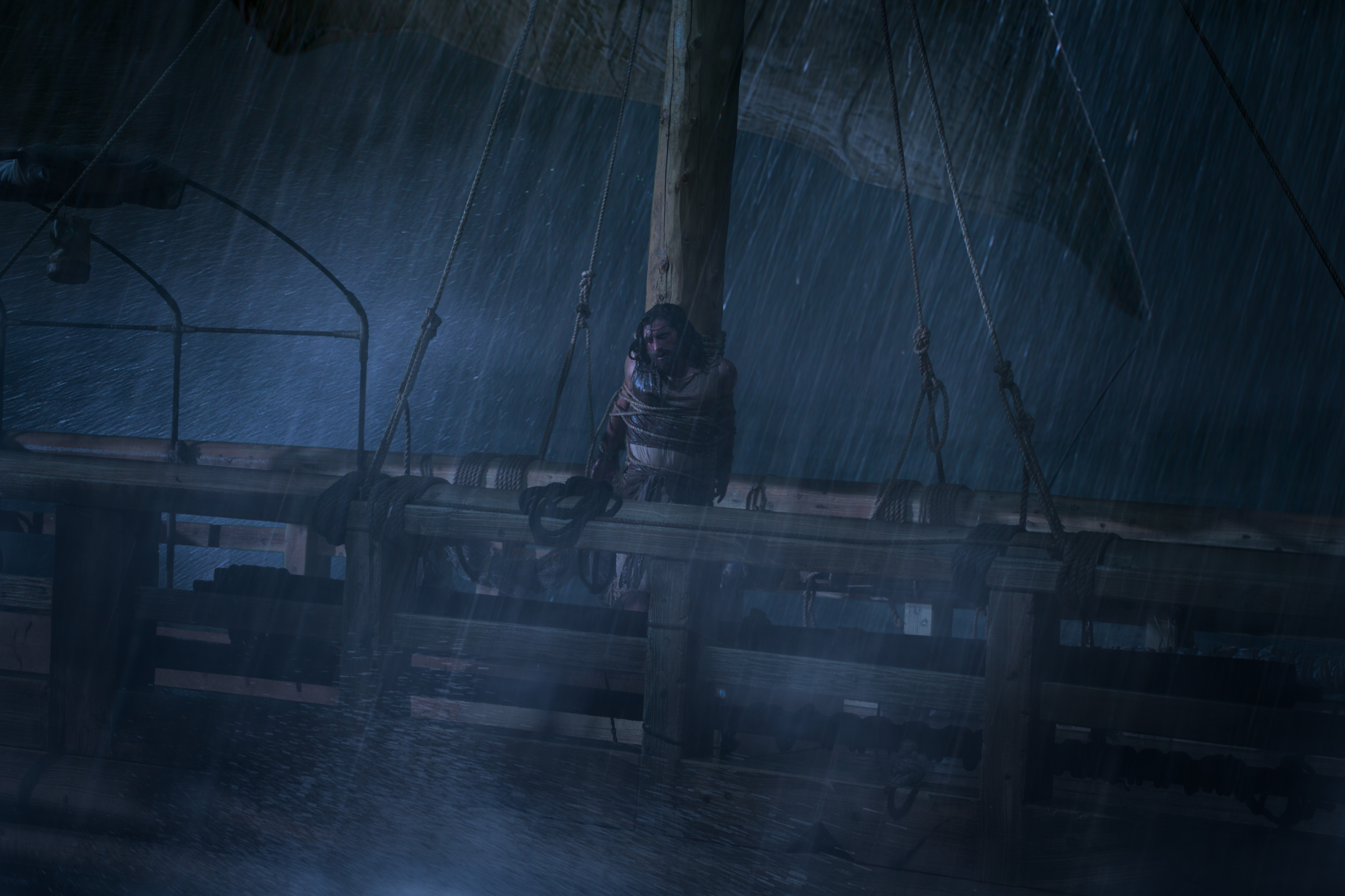 Nephi is tied to the ship's mast as a storm rages around him.
