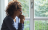 woman pondering by window