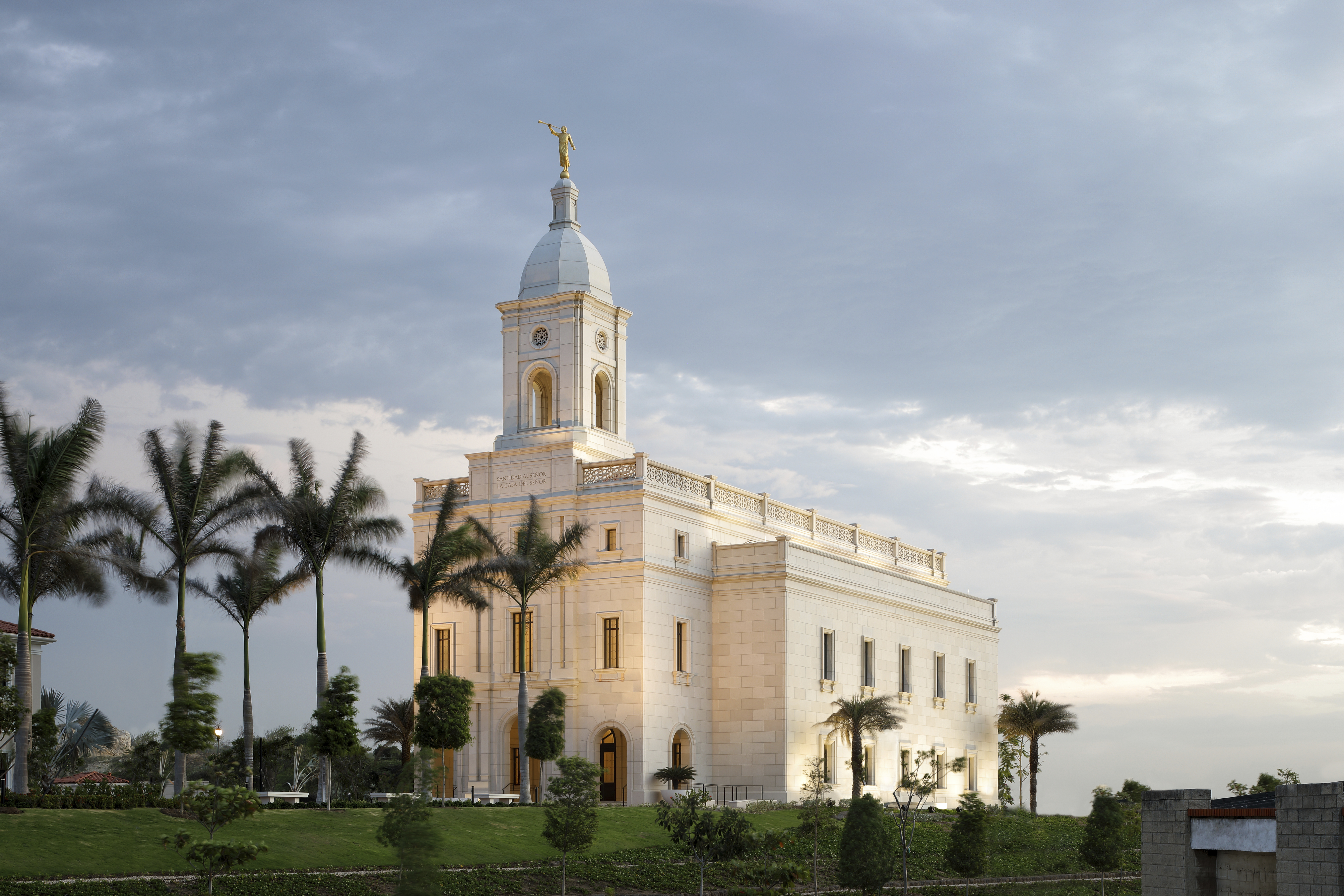 An evening picture of the Barranquilla Colombia Temple surrounded by palm t...