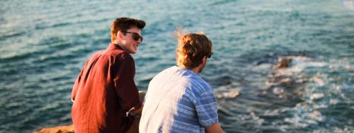 people talking near water