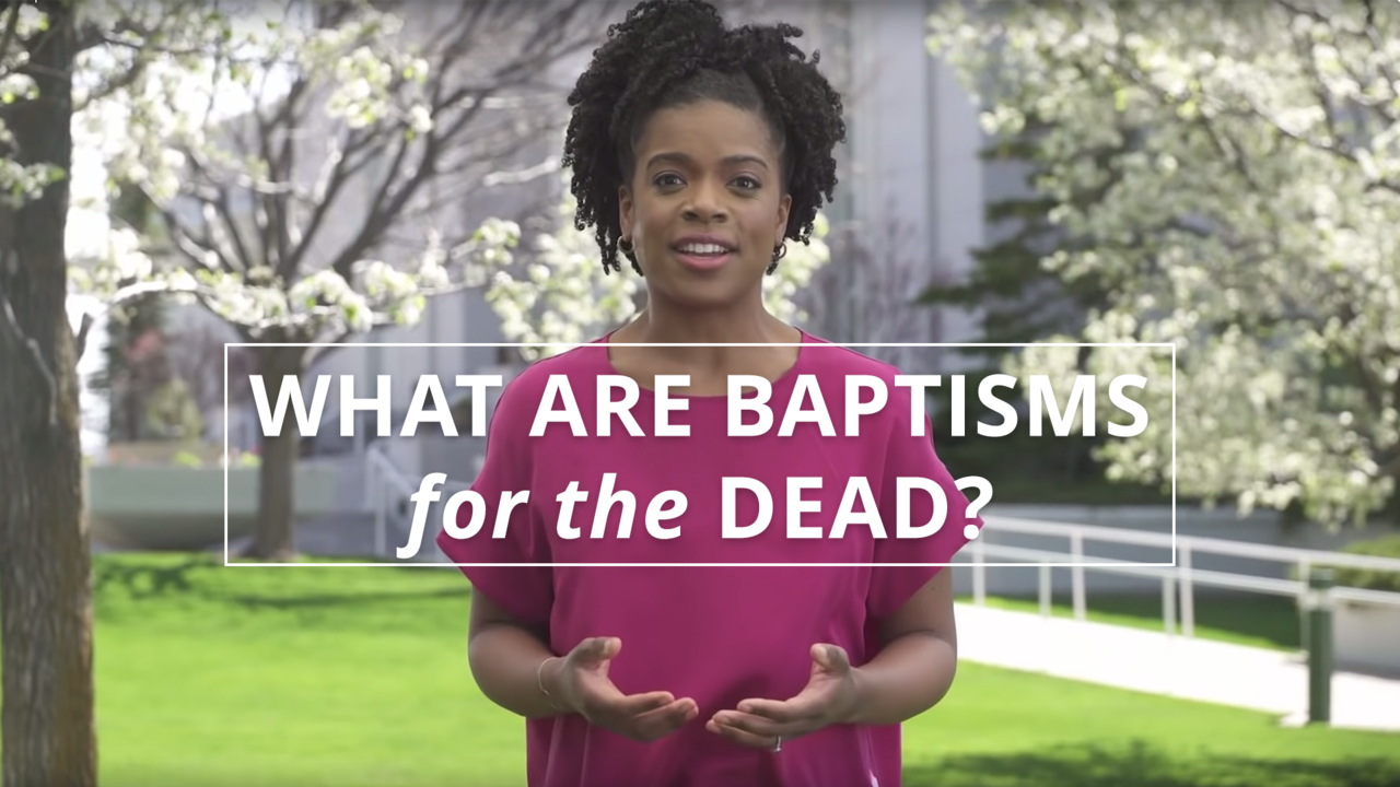A woman stands outside a temple in spring and explains the purpose of baptisms for the dead