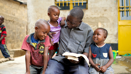 Father reading scriptures