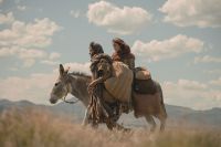 Mary and Joseph walk with a donkey
