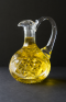 Crystal decanter of olive oil on black background