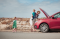 Mother examining broken down car
