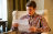 young man reading paper