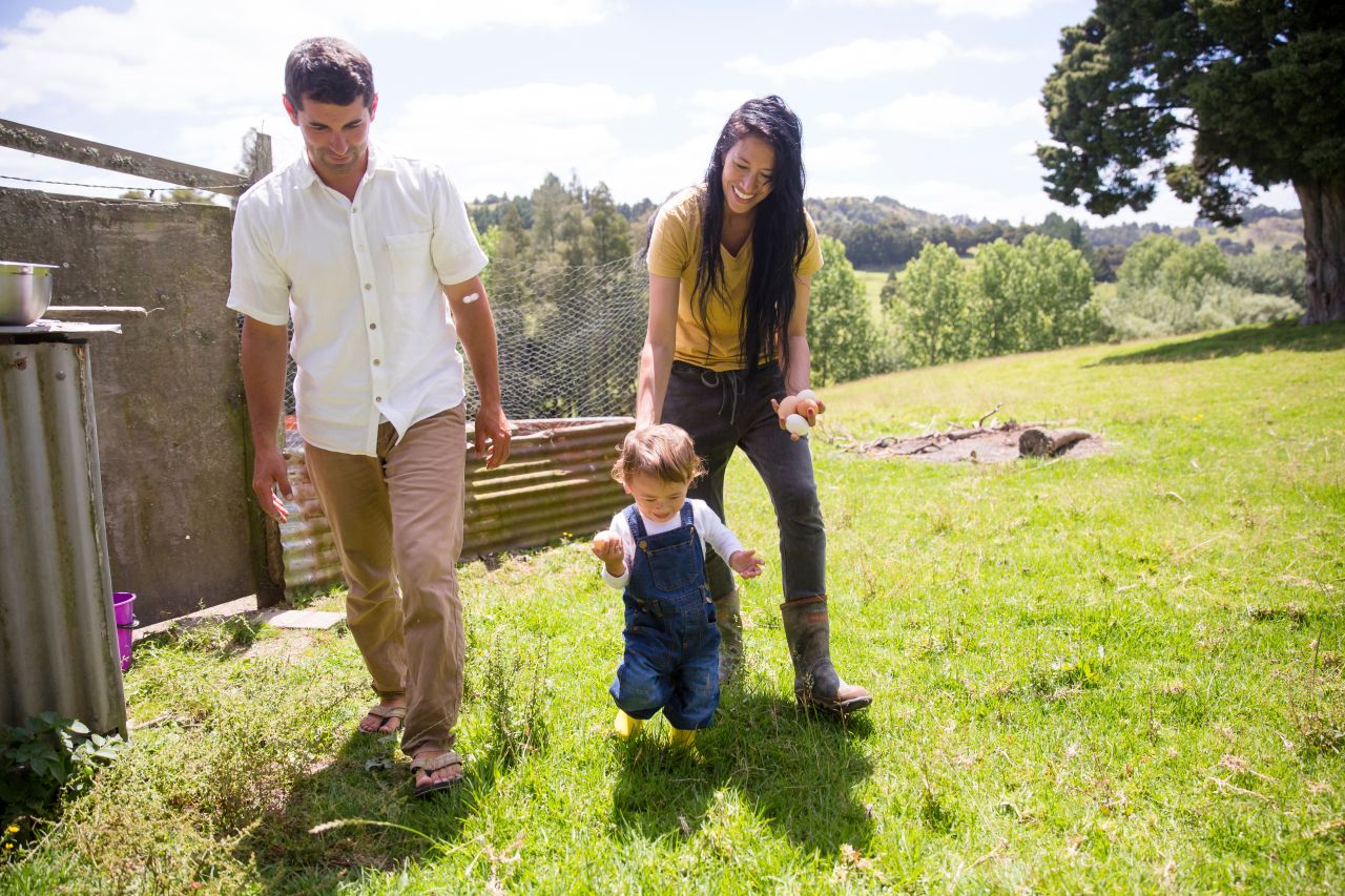 A young couple play with their child spending time with family a good Sabbath activity