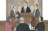 man behind pulpit, with people gathered around