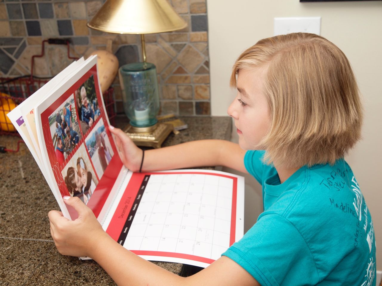Girl looking at a Light the World Christmas calendar