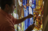 artist working on stained glass mural