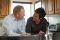 man and woman talking in kitchen
