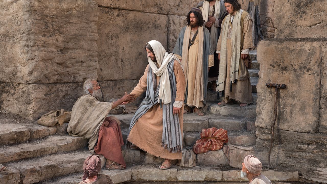 Jesus Christ speaks with a man at the Pool of Bethesda whom he heals on the sabbath