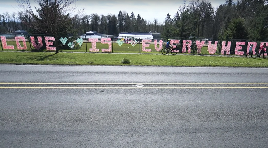 A biker rides past a sign
