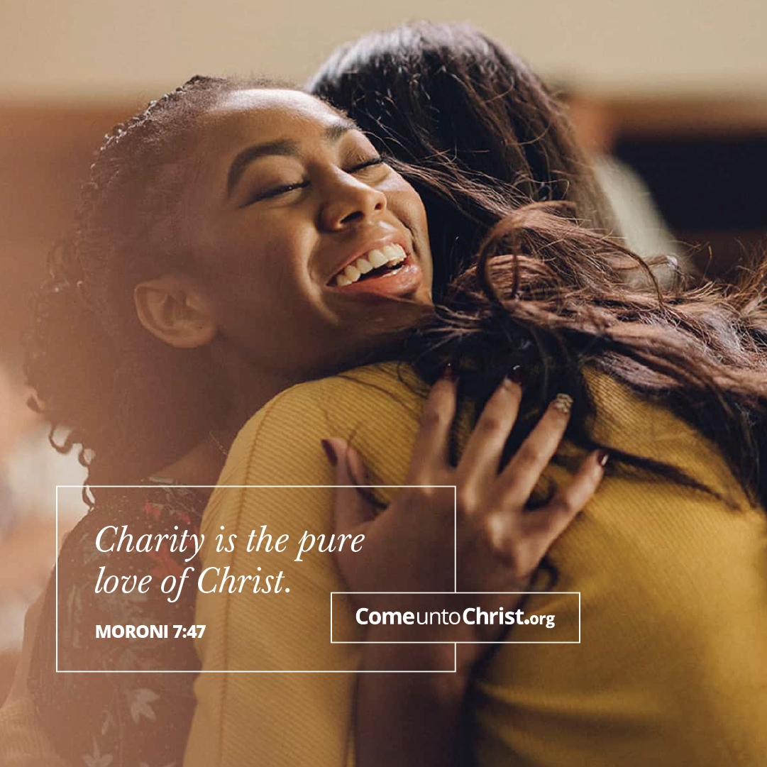 Two women hug each other in a church hall