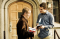 man handing Book of Mormon to other man