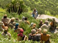 Jesus Christ sits with His disciples and teaches them His gospel