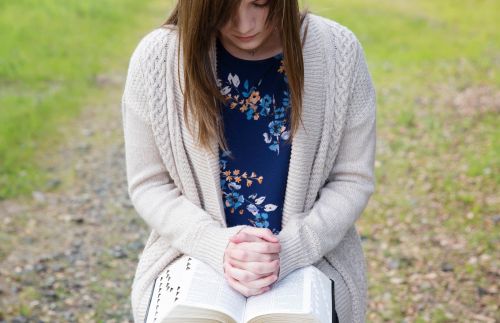 Young woman reading her scriptures