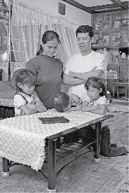 Family kneeling in prayer