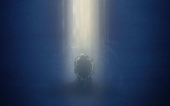 A man kneels in prayer