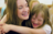 Primary teacher hugging child with Down syndrome