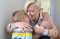 Mother holding baby consoling boy