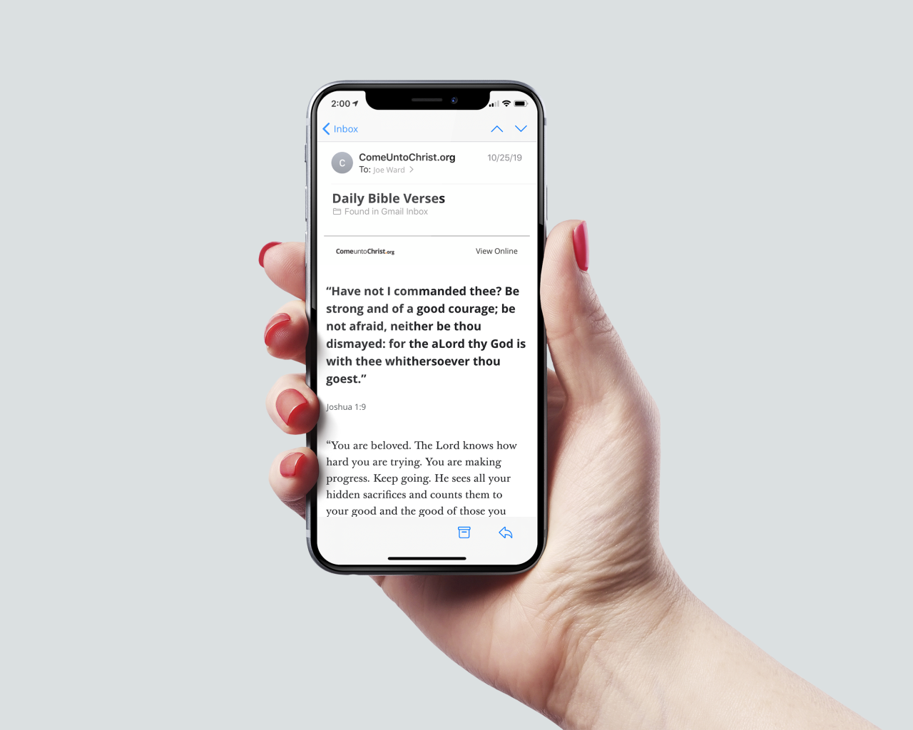 A woman holds a phone containing Joshua 1:9