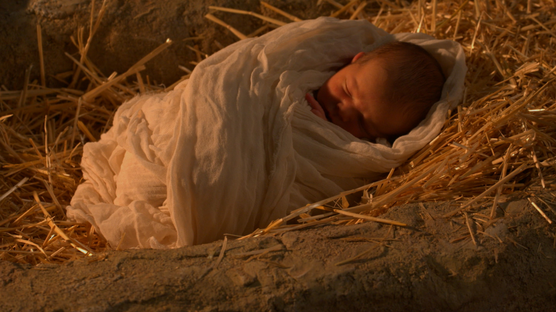 Baby Jesus wrapped in cloth in the manger