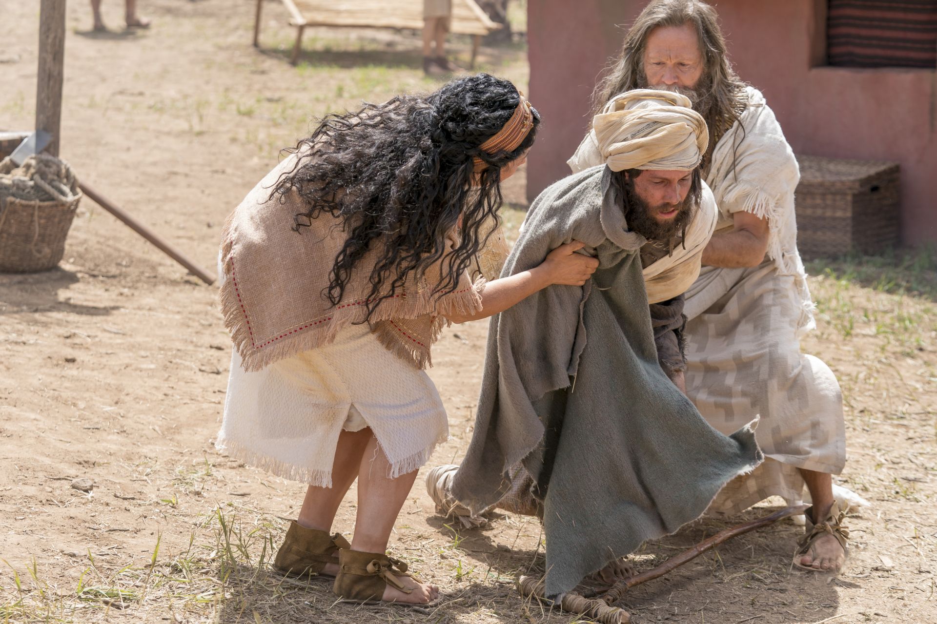 Jacob and his wife helping a crippled man