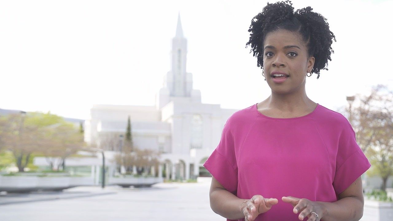 A woman stands outside a Temple and explains why people marry in Temples