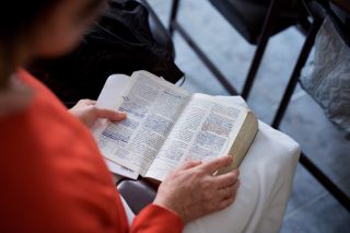 A woman reads about the Ten Commandments in the Bible